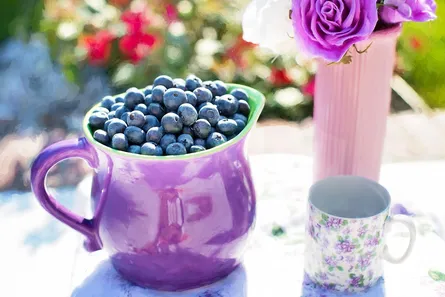 Purple pot on table with flowers