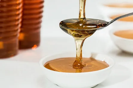 Honey pouring into bowl