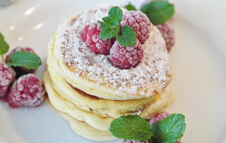 Pancakes with raspberries and mint leaves