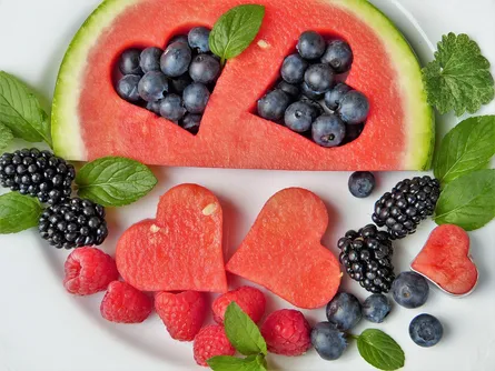 Watermelon slices, blueberries and raspberries on a plate