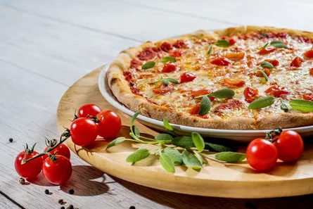 Uncooked pizza on wooden table