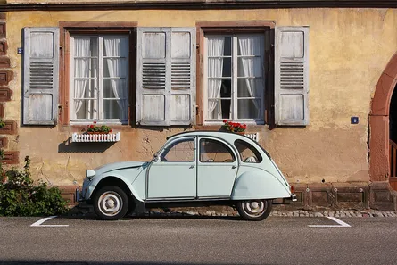 Antique car parked in front of a house