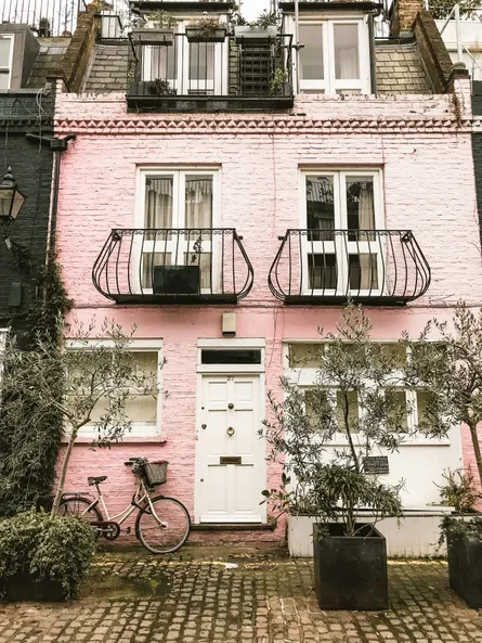 Pink brick building with balcony