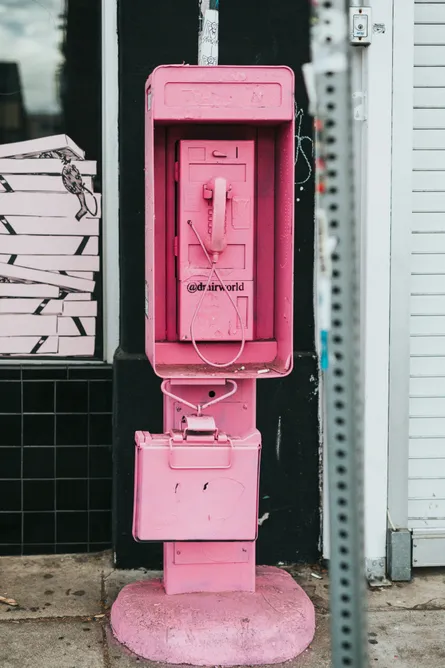 Pink phone in front of building