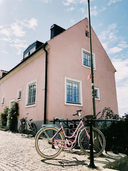 Pink building on cobblestone street