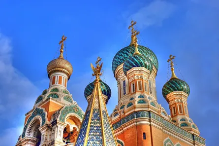 Colorful church with domes and crosses on top