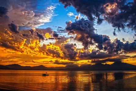 Sunset on lake, clouds reflecting sunlight