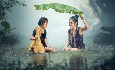 Two women, one with umbrella