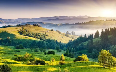 Aerial view of hilly countryside under sun